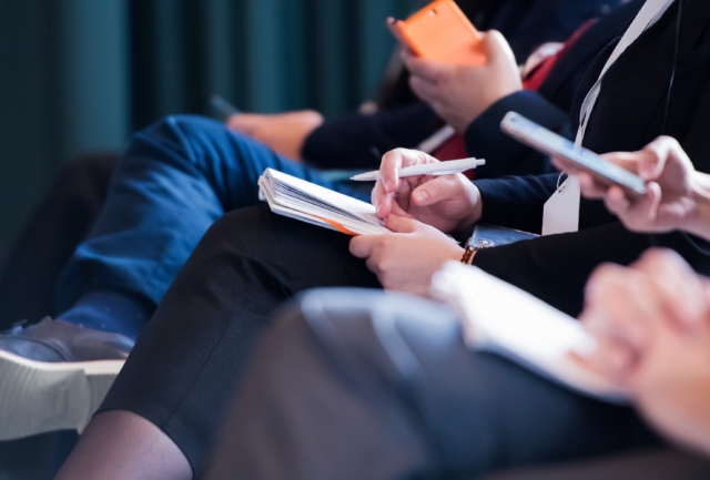 Close Up Of Business People Taking Notes