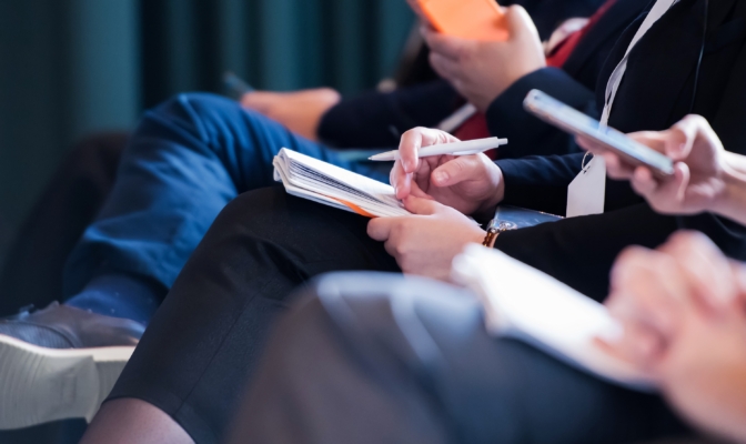 Close Up Of Business People Taking Notes